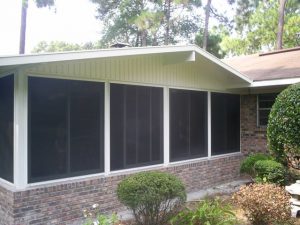 Beautiful screen room addition onto brick home. Brick knee wall to match home exterior.